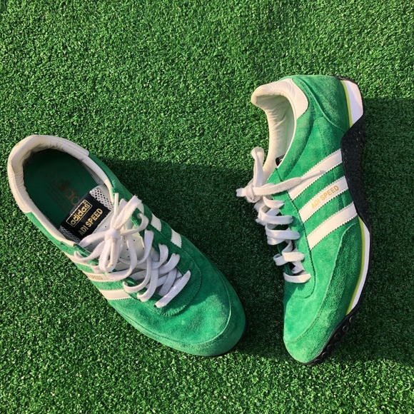 green and white adidas trainers